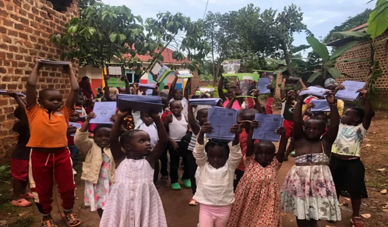 Children display books received as a donation