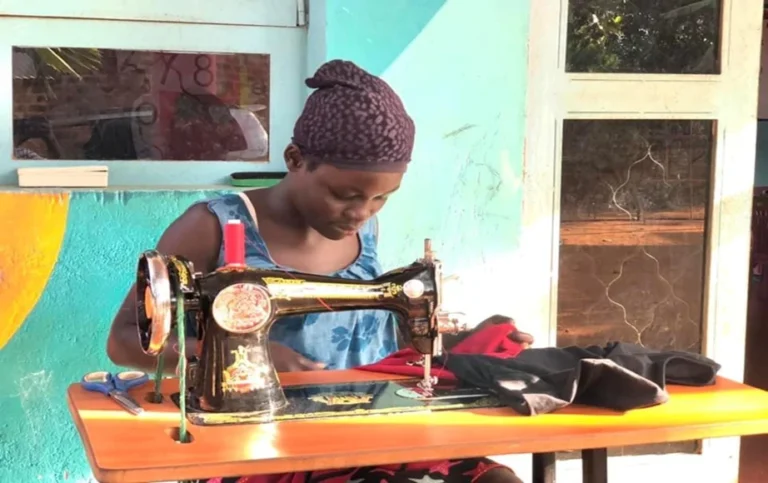 One of the teenage - single mothers during her tailoring training